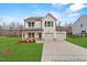 Charming two-story home with a two car garage, cozy front porch, and well-manicured lawn at 169 Horseshoe Pl # 55, Angier, NC 27501