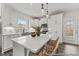 Well-lit kitchen featuring stainless steel appliances, a quartz island, and direct access to the backyard at 169 Horseshoe Pl # 55, Angier, NC 27501