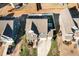 Aerial view of a two-story home with a well-maintained lawn, a two-car garage, and a basketball hoop in the backyard at 1716 Longmont Dr, Wake Forest, NC 27587