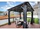 Outdoor deck with gazebo, seating, and charming lights for outdoor relaxation and entertaining at 1716 Longmont Dr, Wake Forest, NC 27587