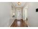 Bright entryway with hardwood floors, a mirrored accent table, a paneled front door and a view into other rooms at 1716 Longmont Dr, Wake Forest, NC 27587