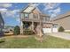 Charming two-story home featuring brick and siding, a covered porch, a two-car garage, and landscaped front yard at 1716 Longmont Dr, Wake Forest, NC 27587