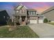 Charming two-story home with brick and siding, a well-manicured lawn, and a three-car garage at 1716 Longmont Dr, Wake Forest, NC 27587