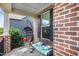 A covered front porch featuring a hanging chair and bench seating creating a cozy outdoor space at 1716 Longmont Dr, Wake Forest, NC 27587