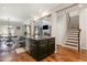 Open-concept kitchen with dark cabinetry, granite countertops, and an island with seating at 1716 Longmont Dr, Wake Forest, NC 27587