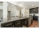 Granite kitchen island with stainless steel appliances and dark cabinets at 1716 Longmont Dr, Wake Forest, NC 27587