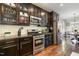 Well-equipped kitchen featuring stainless steel appliances, dark cabinets, and tile backsplash at 1716 Longmont Dr, Wake Forest, NC 27587