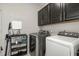 Well-equipped laundry room with modern washer, dryer, and storage cabinets for convenience at 1716 Longmont Dr, Wake Forest, NC 27587