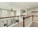 Carpeted upper loft features wood railing, recessed lighting, and abundant natural light at 1716 Longmont Dr, Wake Forest, NC 27587