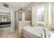 Bathroom featuring a soaking tub, glass shower, and natural light at 1716 Longmont Dr, Wake Forest, NC 27587