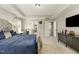Spacious carpeted bedroom featuring a large bed, tray ceiling, desk, and TV at 1716 Longmont Dr, Wake Forest, NC 27587