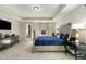 Spacious carpeted bedroom featuring a large bed, tray ceiling, and a closet at 1716 Longmont Dr, Wake Forest, NC 27587