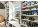 Well-organized walk-in closet featuring ample shelving, natural light, and carpeted floors at 1716 Longmont Dr, Wake Forest, NC 27587