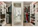 Well-organized walk-in closet featuring ample shelving, hanging space, and a full-length mirror at 1716 Longmont Dr, Wake Forest, NC 27587