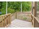 Backyard showing a portion of a screened in porch with stairs and wooded surroundings at 176 Lowery Ln, Benson, NC 27504