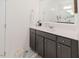 Bathroom featuring gray vanity with white countertop, framed mirror and decor at 176 Lowery Ln, Benson, NC 27504
