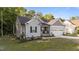 Well-maintained home with gray siding, black shutters, a two-car garage, and manicured landscaping at 176 Lowery Ln, Benson, NC 27504