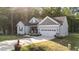 Beautifully landscaped home with a two-car garage, front porch, and a well-manicured lawn at 176 Lowery Ln, Benson, NC 27504