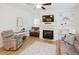 Inviting living room with a fireplace, shelving, and a comfortable armchair at 176 Lowery Ln, Benson, NC 27504