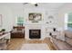 Elegant living room with a fireplace, built-in bookcase, and wood flooring at 176 Lowery Ln, Benson, NC 27504