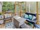 Cozy screened porch featuring comfortable seating, rug, and a view of the surrounding nature at 176 Lowery Ln, Benson, NC 27504