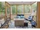 Spacious screened porch featuring outdoor furniture, wood floors and a lovely backyard view at 176 Lowery Ln, Benson, NC 27504
