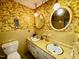 Retro bathroom with double sinks, tiled walls, and a unique floral wallpaper at 1818 Brookrun Rd, Henderson, NC 27536