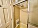 Bathroom shower/tub with glass enclosure, and tiled walls at 1818 Brookrun Rd, Henderson, NC 27536