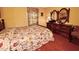 Cozy bedroom with floral bedding, wooden furniture, carpeted floors and vintage charm at 1818 Brookrun Rd, Henderson, NC 27536