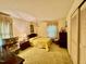 Bedroom includes yellow carpets, patterned drapes, and closet doors at 1818 Brookrun Rd, Henderson, NC 27536