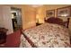 Bedroom with carpeted floors, floral bedding, wooden furniture, and ample closet space at 1818 Brookrun Rd, Henderson, NC 27536