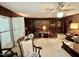 Den with wood paneling, ceiling fan, and access to exterior at 1818 Brookrun Rd, Henderson, NC 27536