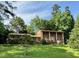 Traditional brick home with well-manicured lawn and mature trees at 1818 Brookrun Rd, Henderson, NC 27536