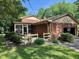 View of back of house with screened in porch and attached garage at 1818 Brookrun Rd, Henderson, NC 27536
