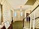 Foyer with wallpaper and front door, viewed from staircase at 1818 Brookrun Rd, Henderson, NC 27536