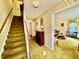 Carpeted foyer with stairway and view into the living room, featuring classic details and traditional design at 1818 Brookrun Rd, Henderson, NC 27536