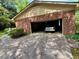 Exterior view of the attached garage with driveway at 1818 Brookrun Rd, Henderson, NC 27536