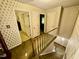 Upstairs landing featuring carpeted floors, wallpaper, and several doorways at 1818 Brookrun Rd, Henderson, NC 27536
