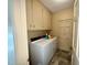 Laundry room with washer, dryer, and overhead cabinet storage at 1818 Brookrun Rd, Henderson, NC 27536