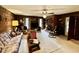 Spacious living room with brick fireplace, ceiling fan, and lots of natural light at 1818 Brookrun Rd, Henderson, NC 27536