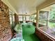 Relax in the screened porch with ample seating and views at 1818 Brookrun Rd, Henderson, NC 27536