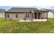 Backyard view of house featuring a patio, furniture and green grass at 1828 Wellspring Ct, Graham, NC 27253
