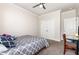 Comfortable carpeted bedroom featuring a ceiling fan and a double-door closet at 1828 Wellspring Ct, Graham, NC 27253