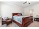 Cozy carpeted bedroom with wood furniture and an open door to the bathroom at 1828 Wellspring Ct, Graham, NC 27253