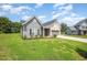Well-maintained single-story home featuring a green lawn and a two-car garage and vinyl siding at 1828 Wellspring Ct, Graham, NC 27253