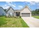 Charming one-story home with a manicured lawn, two-car garage, and brick and vinyl siding at 1828 Wellspring Ct, Graham, NC 27253
