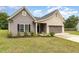 Charming single-story home with a mix of brick and vinyl siding, well-kept lawn, and an attached two-car garage at 1828 Wellspring Ct, Graham, NC 27253