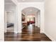 Bright hallway with hardwood floors, arched doorways, and views into the living room and bedroom at 1828 Wellspring Ct, Graham, NC 27253