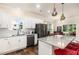 Well-lit kitchen with white cabinetry, stainless steel appliances, and an island with barstools at 1828 Wellspring Ct, Graham, NC 27253