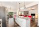 Open kitchen with granite island and view of the living area with a stone fireplace at 1828 Wellspring Ct, Graham, NC 27253